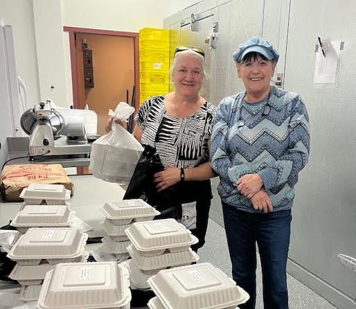 Volunteers packing meals for delivery.
